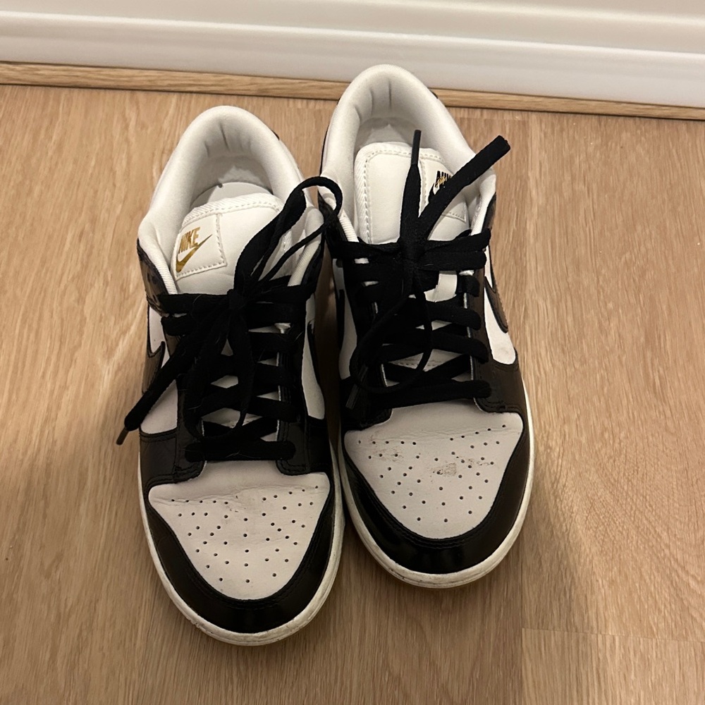 Nike women’s  Black and White Sneakers with Gold Accents